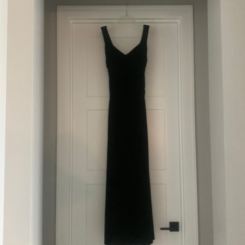 Floor length dress.  Flattering neck line. Zipper back. Ruched mid section.